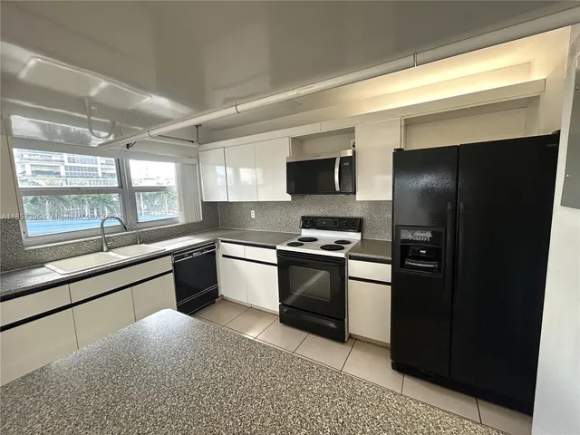 a kitchen with a refrigerator and a stove