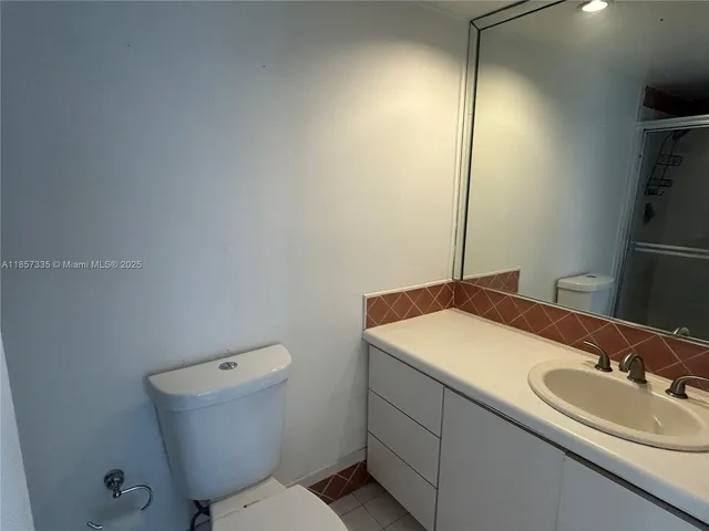 a bathroom with a sink toilet vanity and tub