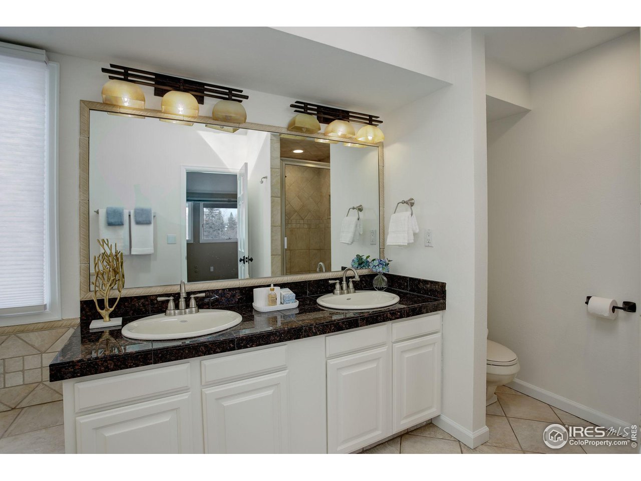 7240 Clubhouse Road Boulder, CO 80301 - Photo 20 of 34 a bathroom with a granite countertop sink and a mirror