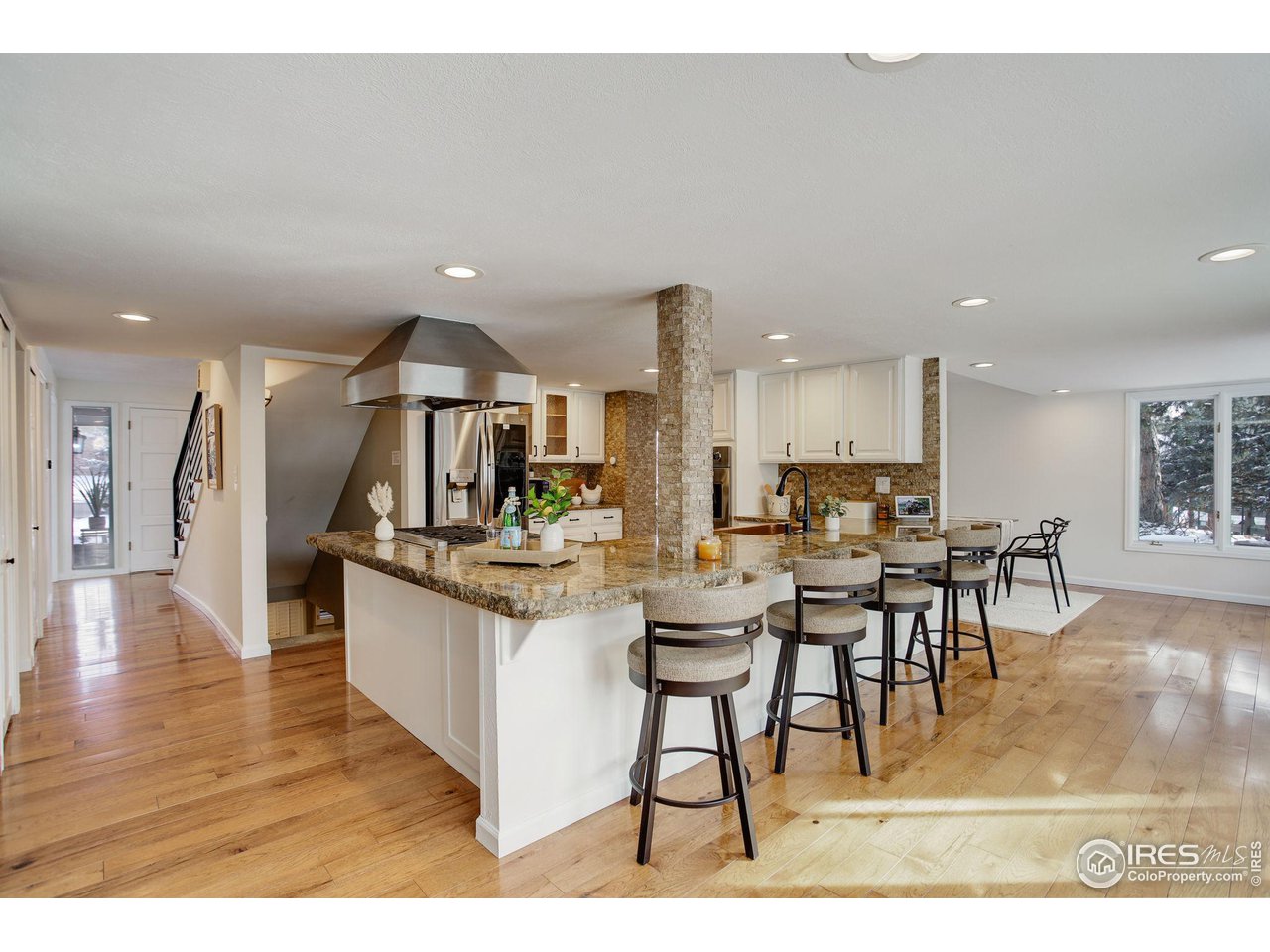7240 Clubhouse Road Boulder, CO 80301 - Photo 2 of 34 a kitchen with stainless steel appliances kitchen island granite countertop a table chairs and a view of living room