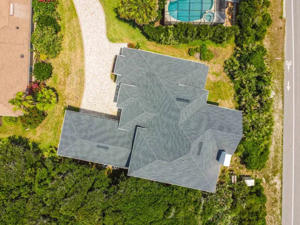 a aerial view of a house with a garden and lake view