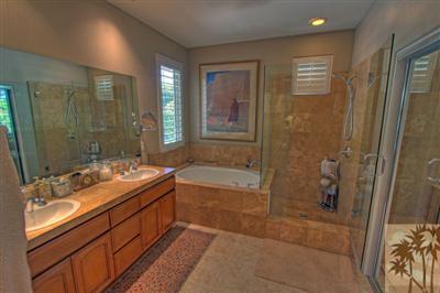 49145 Rio Arenoso La Quinta, CA 92253 - Photo 11 of 18 a bathroom with a double vanity sink and mirror with shower