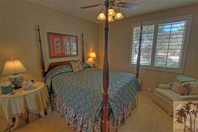 49145 Rio Arenoso La Quinta, CA 92253 - Photo 13 of 18 a bedroom with a bed and a chandelier