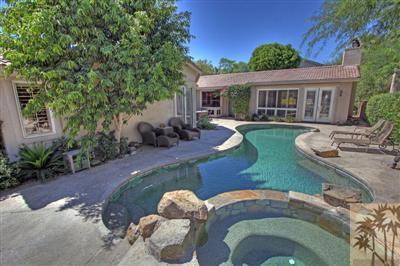 49145 Rio Arenoso La Quinta, CA 92253 - Photo 2 of 18 a front view of house with yard seating and green space