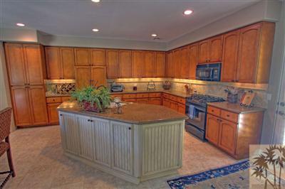 49145 Rio Arenoso La Quinta, CA 92253 - Photo 5 of 18 a kitchen with stainless steel appliances granite countertop a stove a sink dishwasher and a refrigerator with wooden cabinets