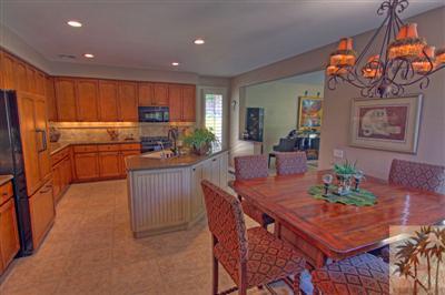 49145 Rio Arenoso La Quinta, CA 92253 - Photo 6 of 18 a kitchen with stainless steel appliances granite countertop a refrigerator a sink a stove and island