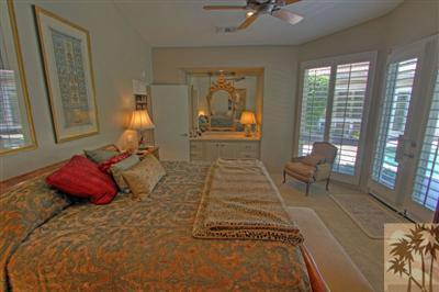 49145 Rio Arenoso La Quinta, CA 92253 - Photo 9 of 18 a bed room with a bed and a chair