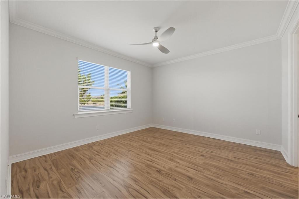 28310 Captiva Shell Loop Bonita Springs, FL 34135 - Photo 12 of 44 Unfurnished room featuring ornamental molding, light wood-style flooring, and ceiling fan