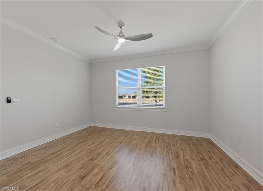 28310 Captiva Shell Loop Bonita Springs, FL 34135 - Photo 13 of 44 Empty room with light wood-type flooring, crown molding, and a ceiling fan