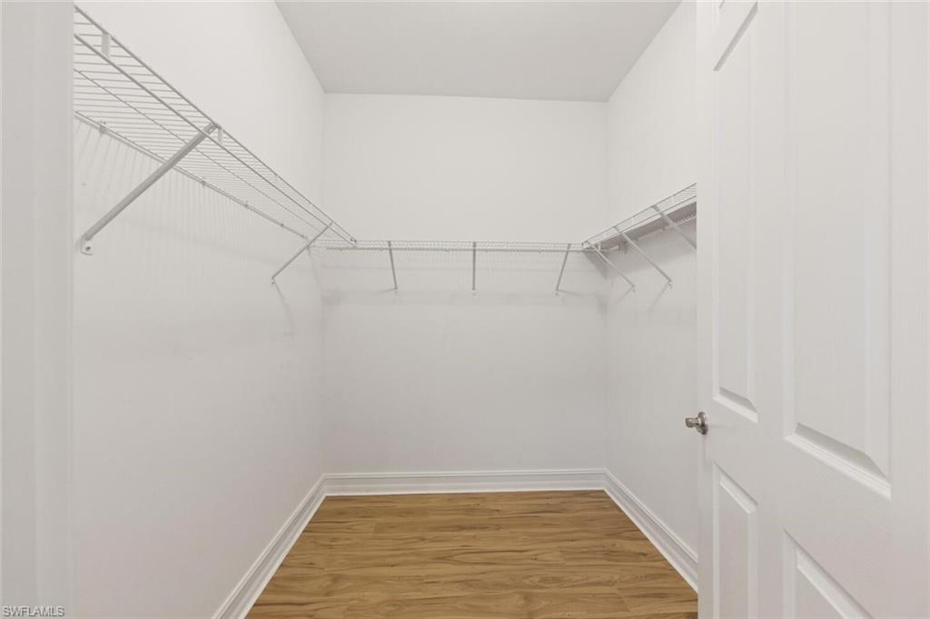28310 Captiva Shell Loop Bonita Springs, FL 34135 - Photo 16 of 44 Walk in closet with light wood-style floors