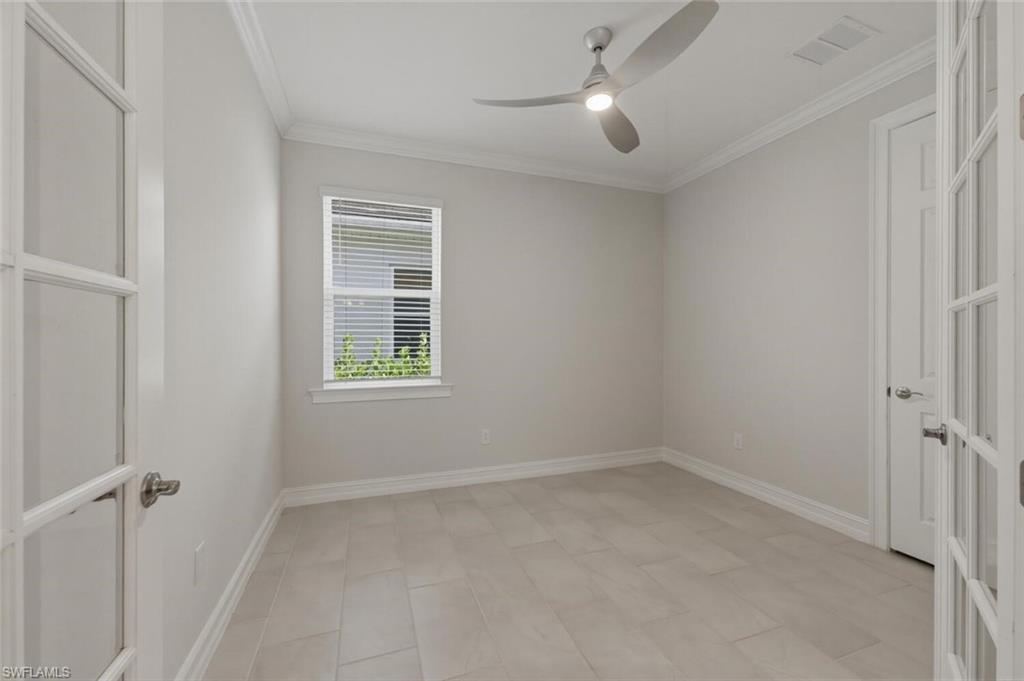 28310 Captiva Shell Loop Bonita Springs, FL 34135 - Photo 20 of 44 Unfurnished room with ornamental molding and ceiling fan