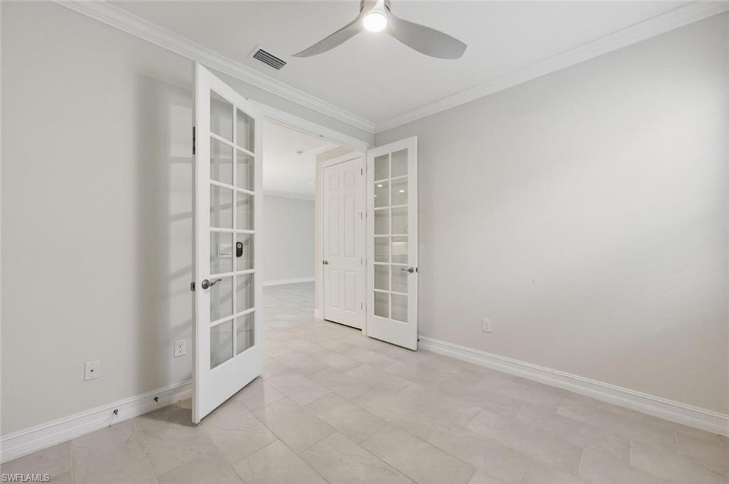 28310 Captiva Shell Loop Bonita Springs, FL 34135 - Photo 21 of 44 Empty room featuring ornamental molding, french doors, and a ceiling fan
