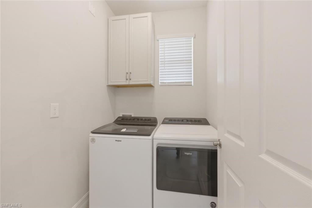 28310 Captiva Shell Loop Bonita Springs, FL 34135 - Photo 22 of 44 Laundry room featuring cabinet space and washing machine and clothes dryer
