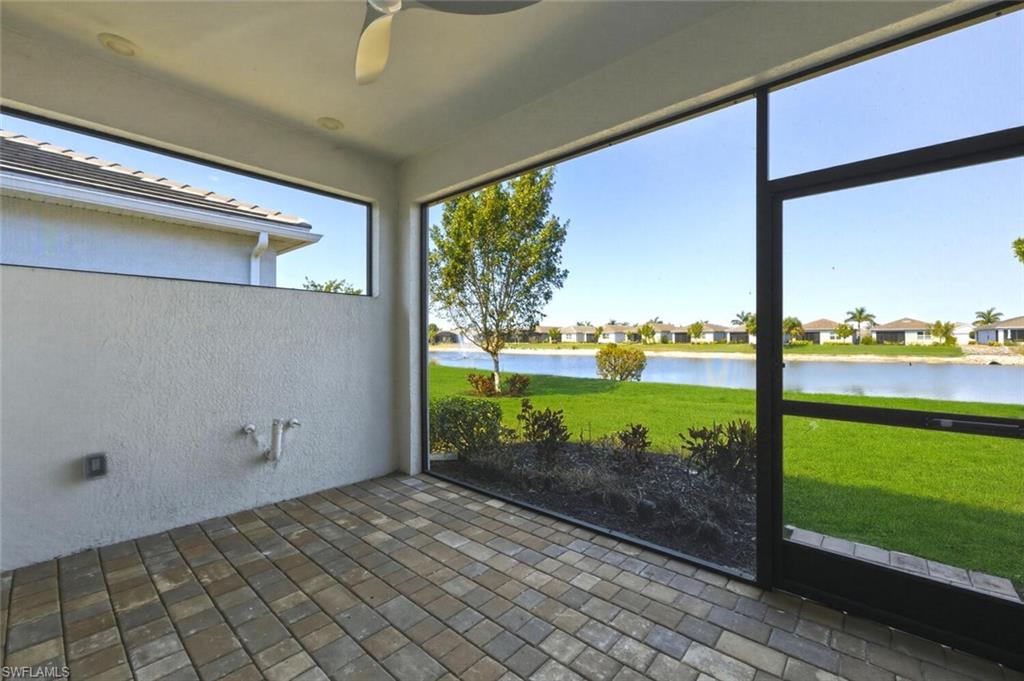 28310 Captiva Shell Loop Bonita Springs, FL 34135 - Photo 23 of 44 Unfurnished sunroom featuring a ceiling fan, a water view, and a patio area