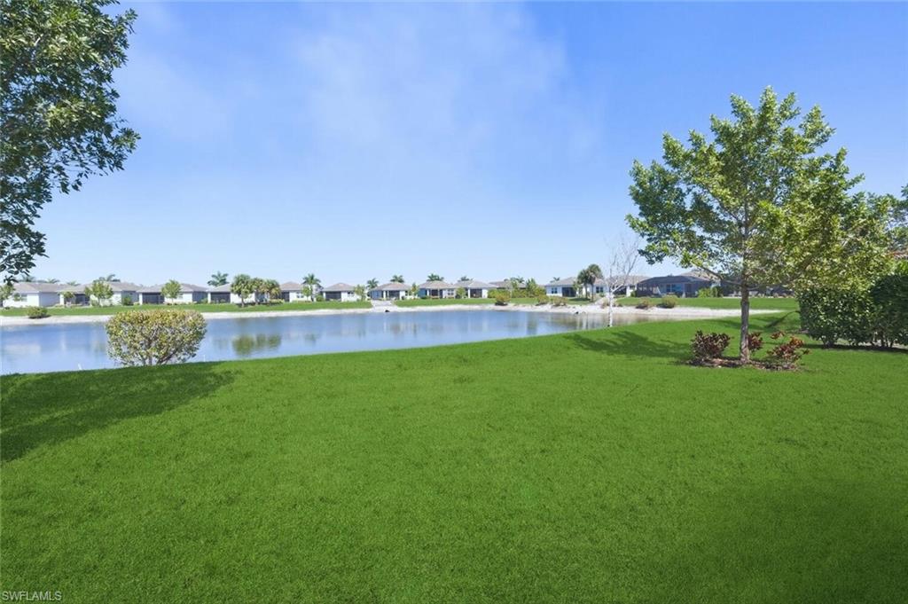 28310 Captiva Shell Loop Bonita Springs, FL 34135 - Photo 27 of 44 View of green lawn with a water view and a residential view