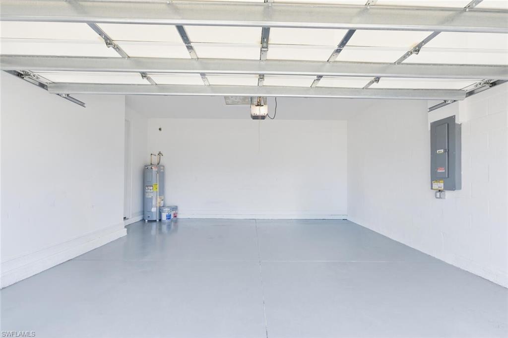 28310 Captiva Shell Loop Bonita Springs, FL 34135 - Photo 29 of 44 Garage featuring electric panel and water heater