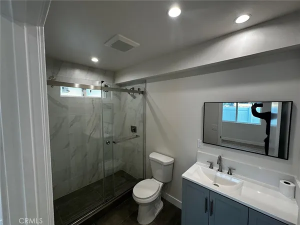 a bathroom with a toilet a sink and shower