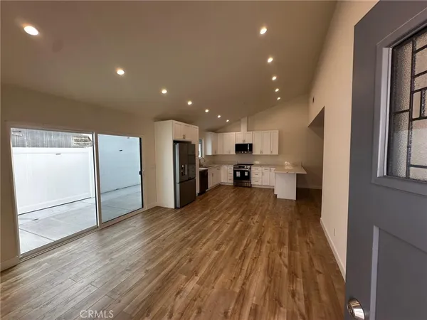 a kitchen with granite countertop a sink stove and cabinets