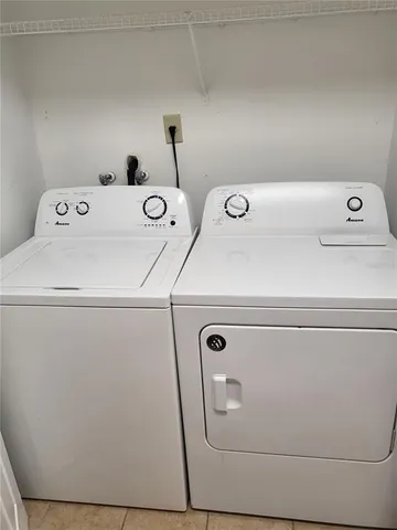 a kitchen with a refrigerator and a stove top oven
