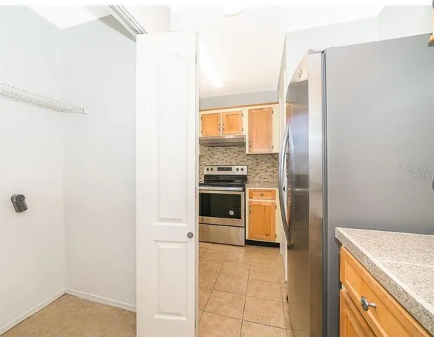 a bathroom with a granite countertop sink a toilet a mirror and shower