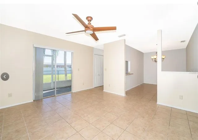 a view of a livingroom with wooden floor and a ceiling fan