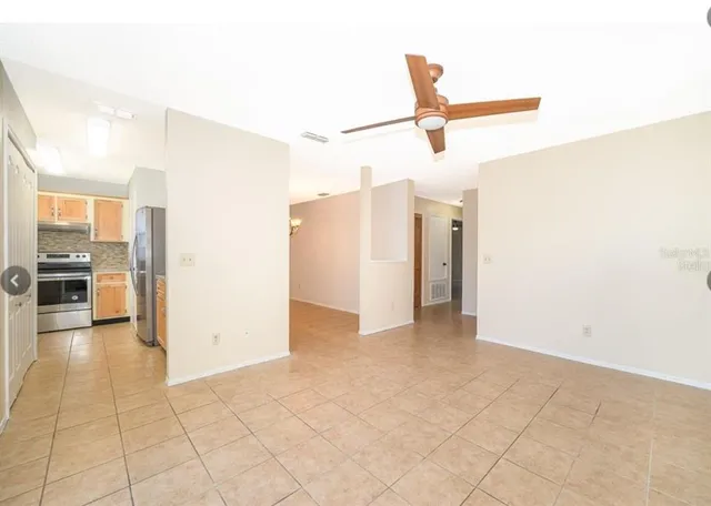 a view of a kitchen with a refrigerator and a stove top oven