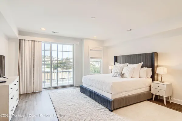 a large bedroom with a large bed and large window