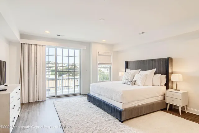 a large bedroom with a large bed and large window