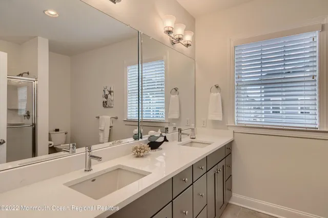 a bathroom with a sink double vanity and a mirror