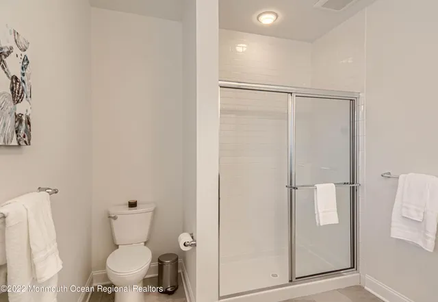 a bathroom with a toilet and a shower