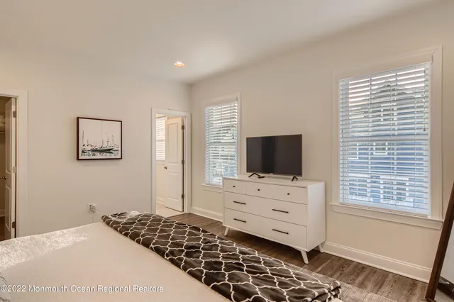 a bedroom with a bed and flat screen tv