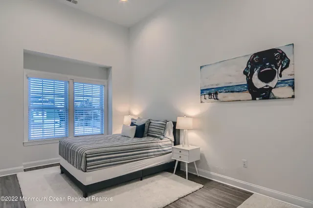 a bedroom with a bed and painting on the wall