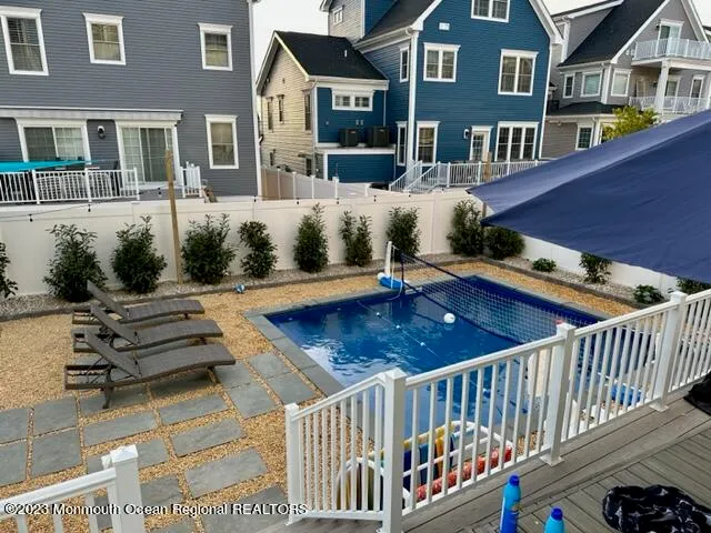 a view of a house with pool and chairs