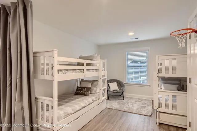 a living room with furniture a flat screen tv and a window