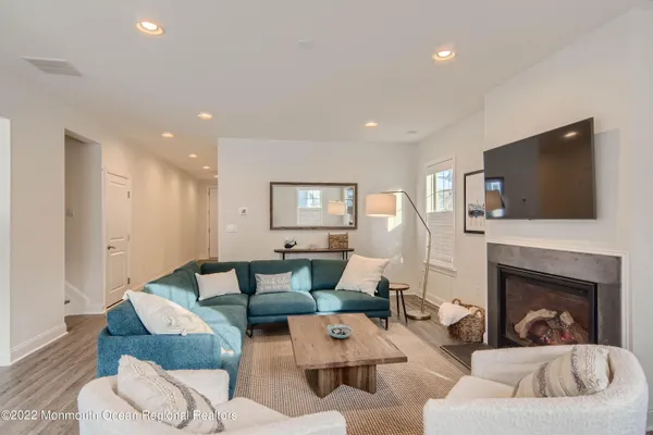 a living room with furniture fireplace and flat screen tv