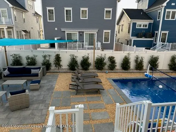 a view of a patio with couches table and chairs and potted plants