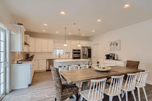 a large kitchen with a table and chairs in it