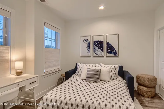 a bedroom with a bed and painting on the wall