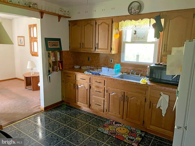 a kitchen with granite countertop a sink stove and cabinets