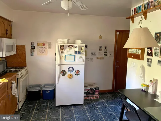 a room with a refrigerator and a table