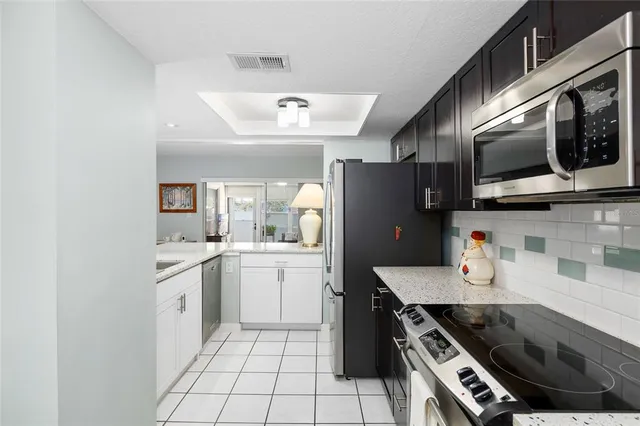 a kitchen with stainless steel appliances a stove a sink and a microwave
