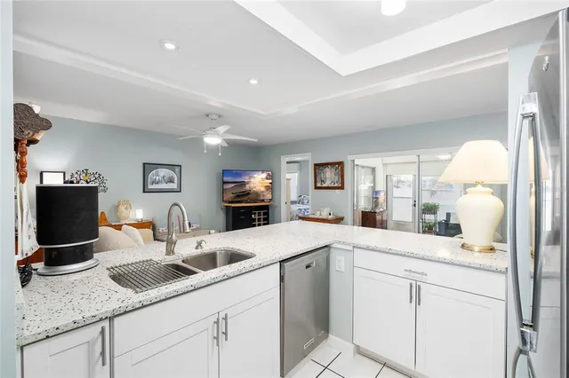 a kitchen with sink and mirror