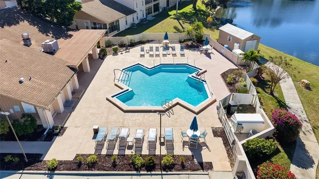an aerial view of residential houses with outdoor space and lake view