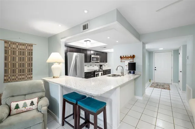 a large white kitchen with a table and chairs