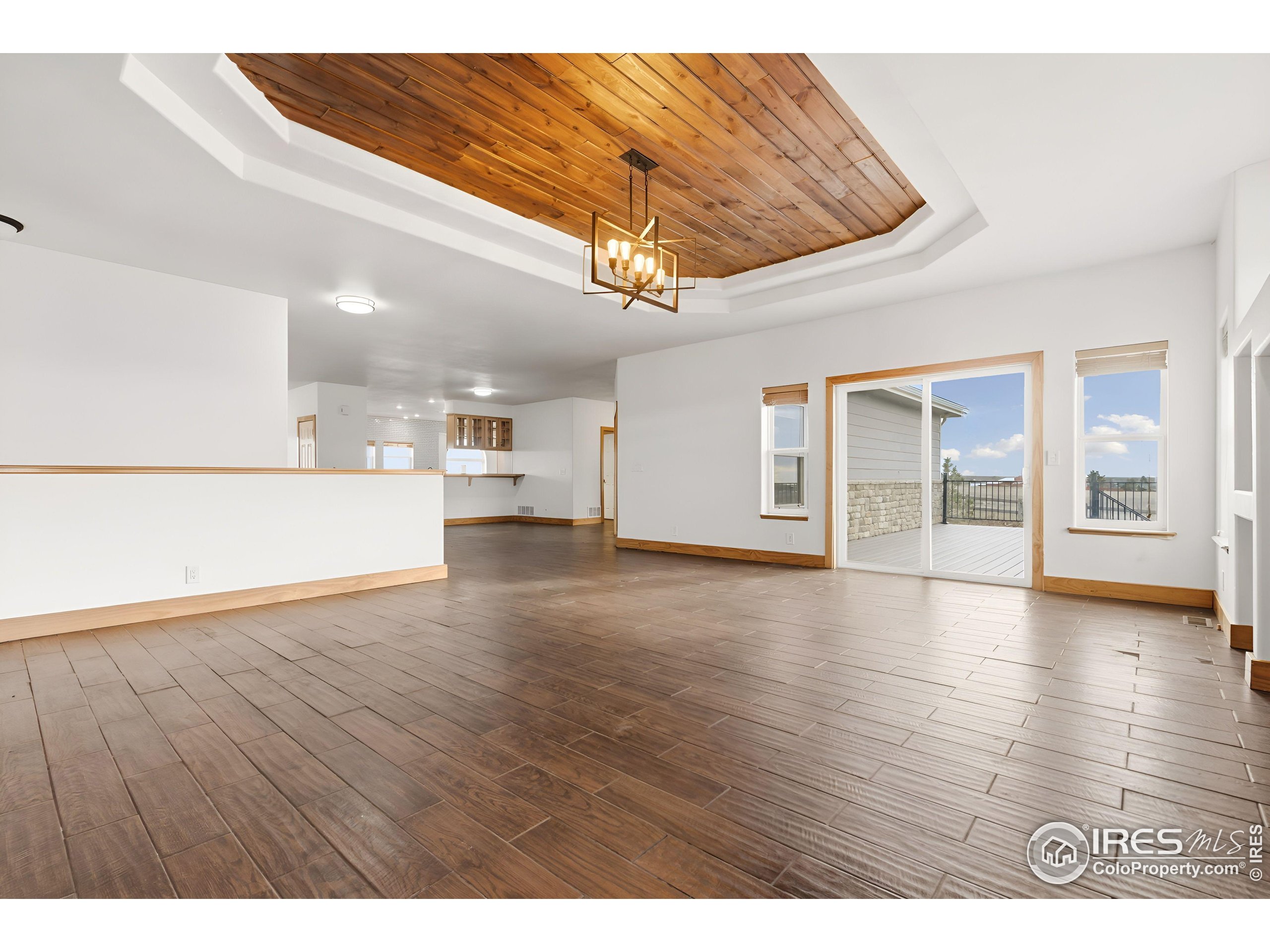 7321 Gilmore Avenue Fort Collins, CO 80524 - Photo 7 of 37 a view of an empty room with wooden floor and a window