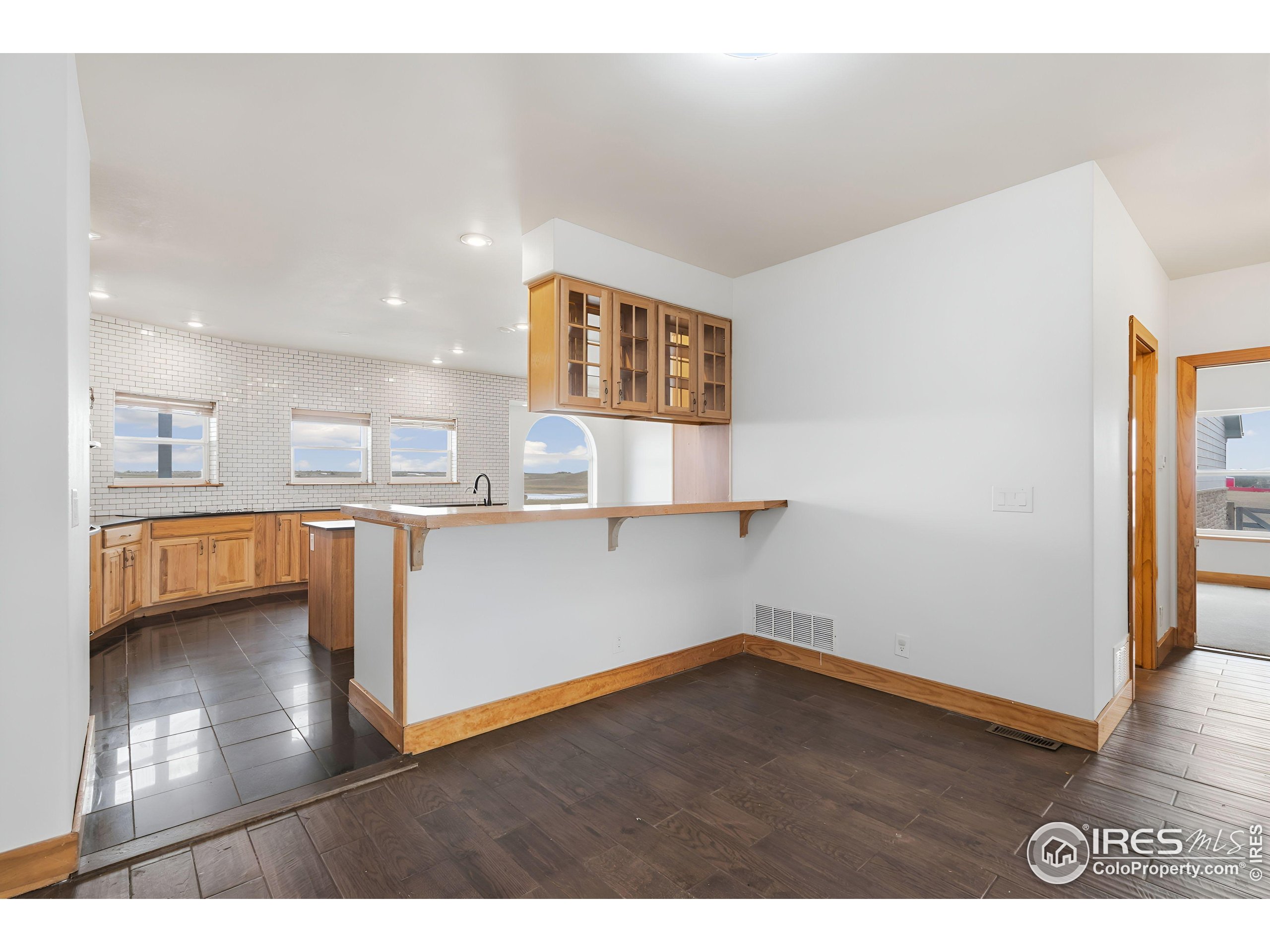 7321 Gilmore Avenue Fort Collins, CO 80524 - Photo 8 of 37 a view of kitchen and hall with wooden floor