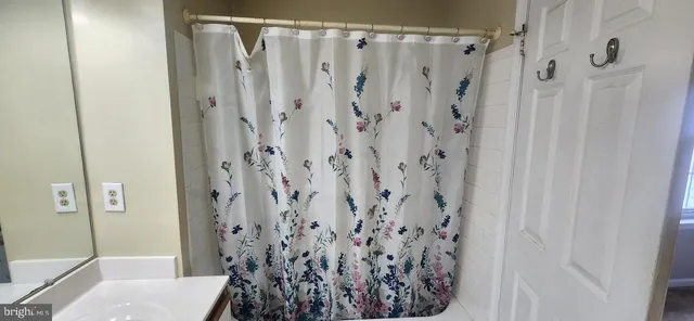 a view of a bathroom with a shower curtain