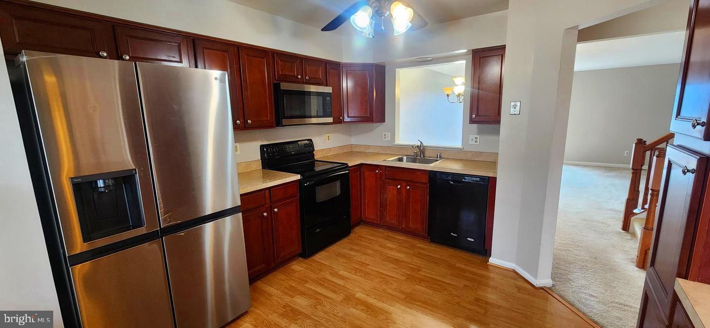 55 Powder View Court Nottingham, MD 21236 - Photo 5 of 20 a kitchen with stainless steel appliances granite countertop a refrigerator a stove top oven a sink and dishwasher