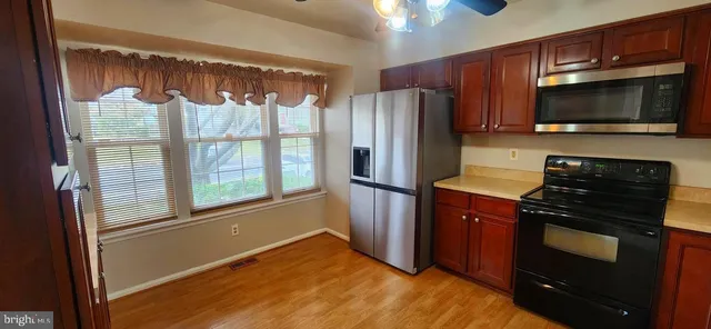 a kitchen with stainless steel appliances a stove microwave and refrigerator