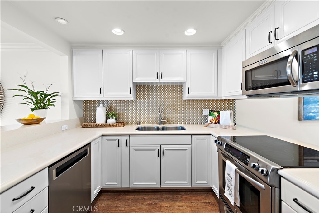 24592 Harbor View Drive, Unit B Dana Point, CA 92629 - Photo 13 of 33 a kitchen with a sink a stove cabinets and appliances